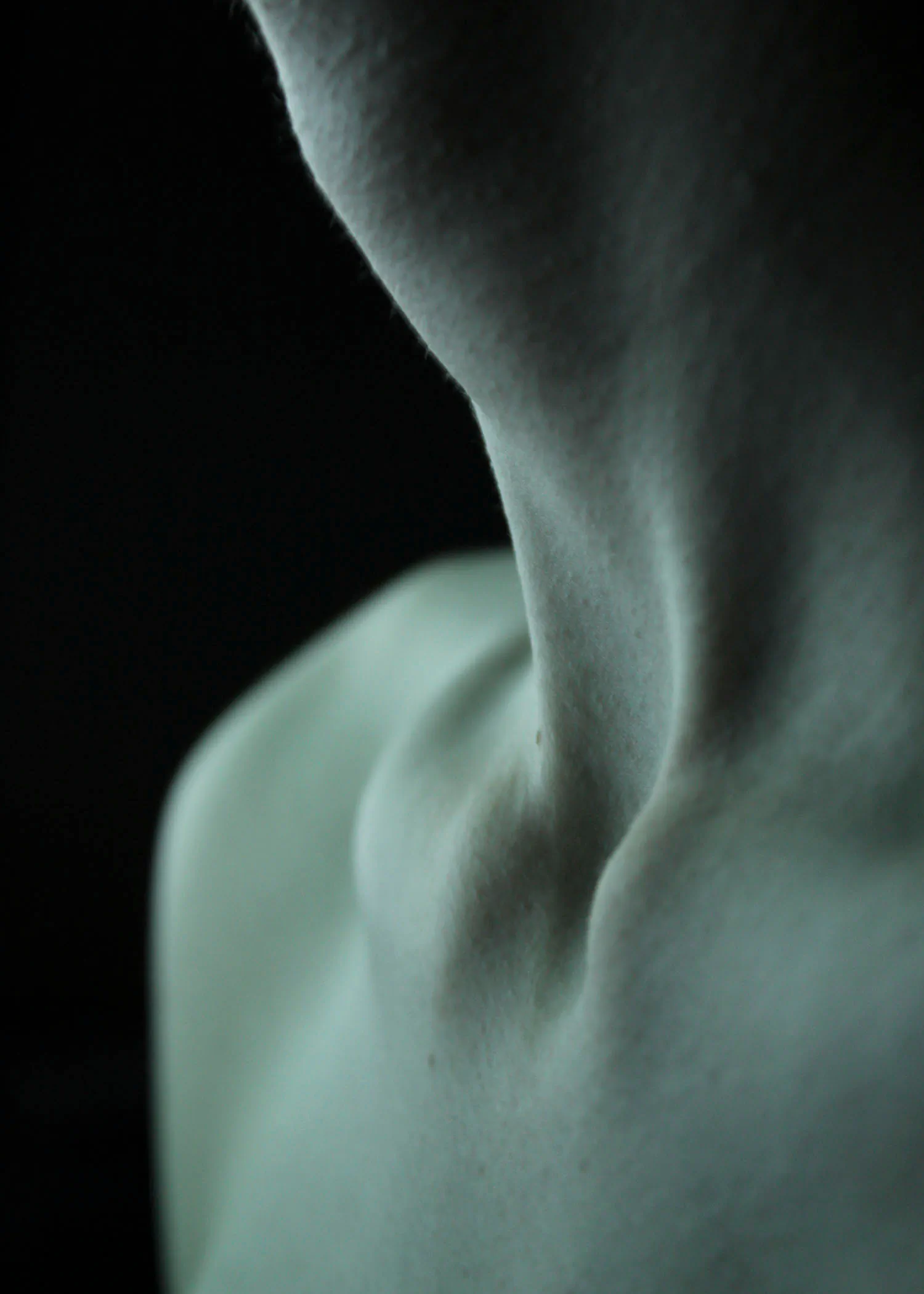 Close up sculptural neck in blue light