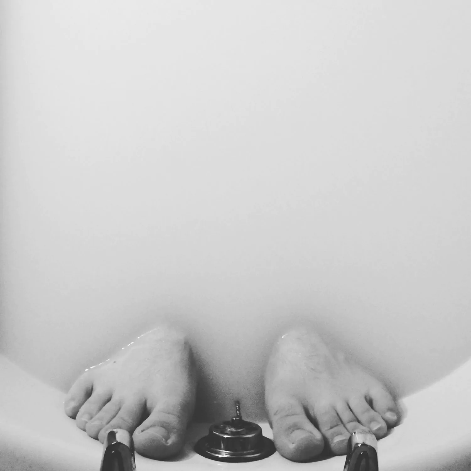 Feet submerged in a milky bath